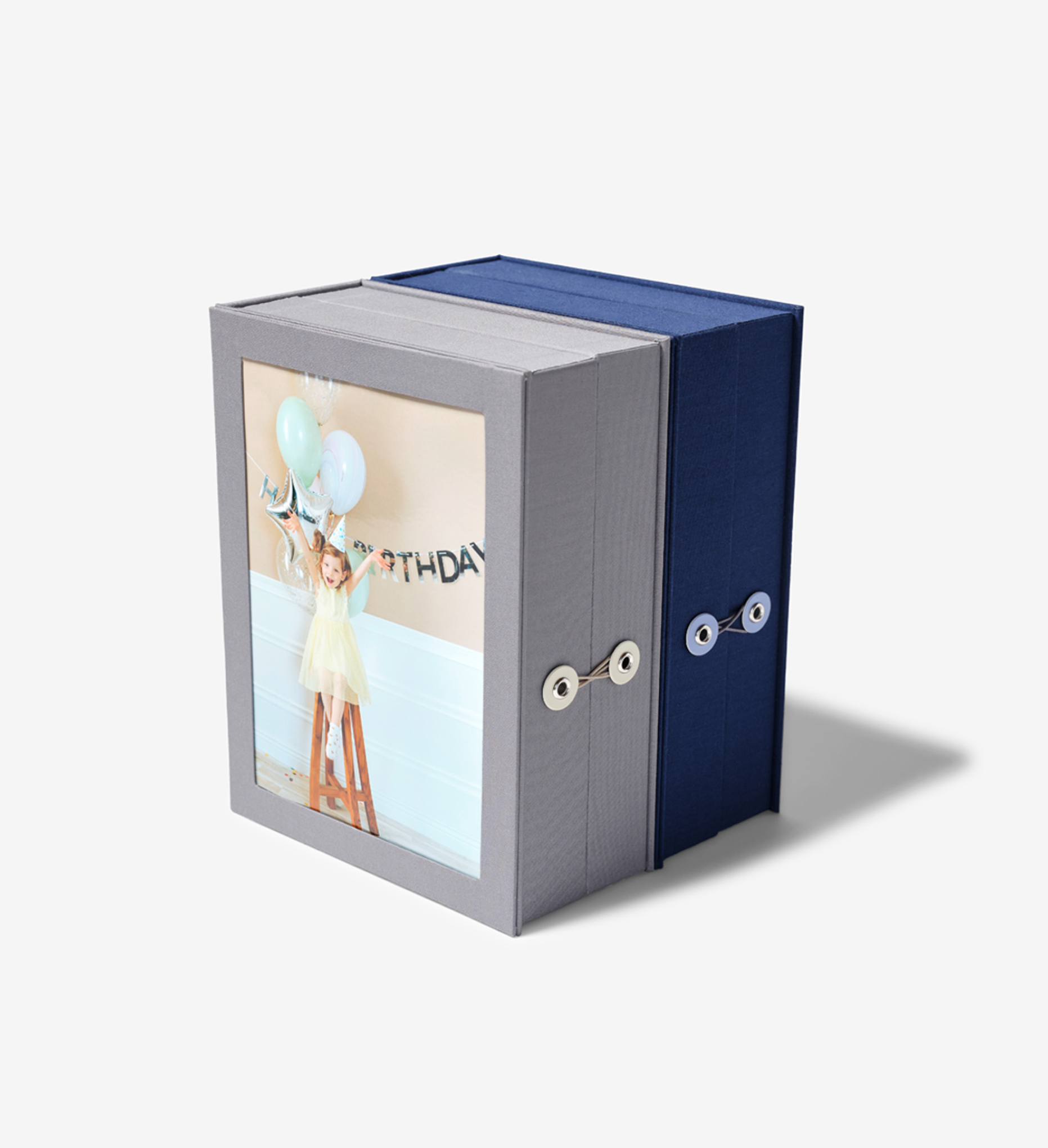 closed slate travel story box and closed something blue travel story box, next to each other.