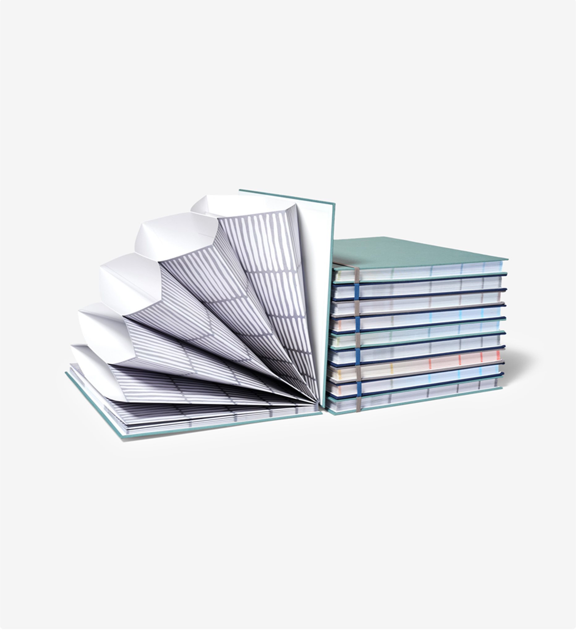 open fan folio with a stack of several fan folios next to it.