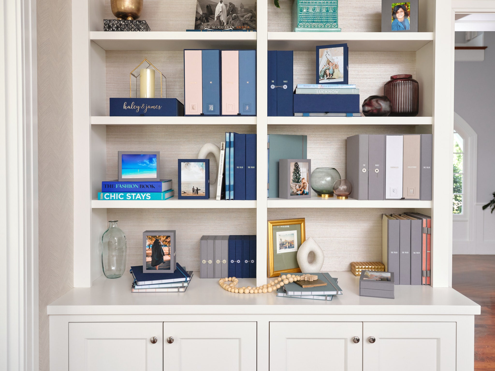 Savor organizers in blue and grey on a shelf, with other house decoration around