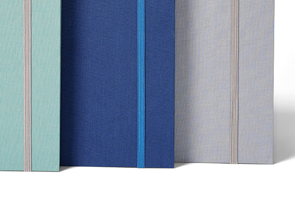 A sage Fan Folio, A something blue one and a slate one next to each other.