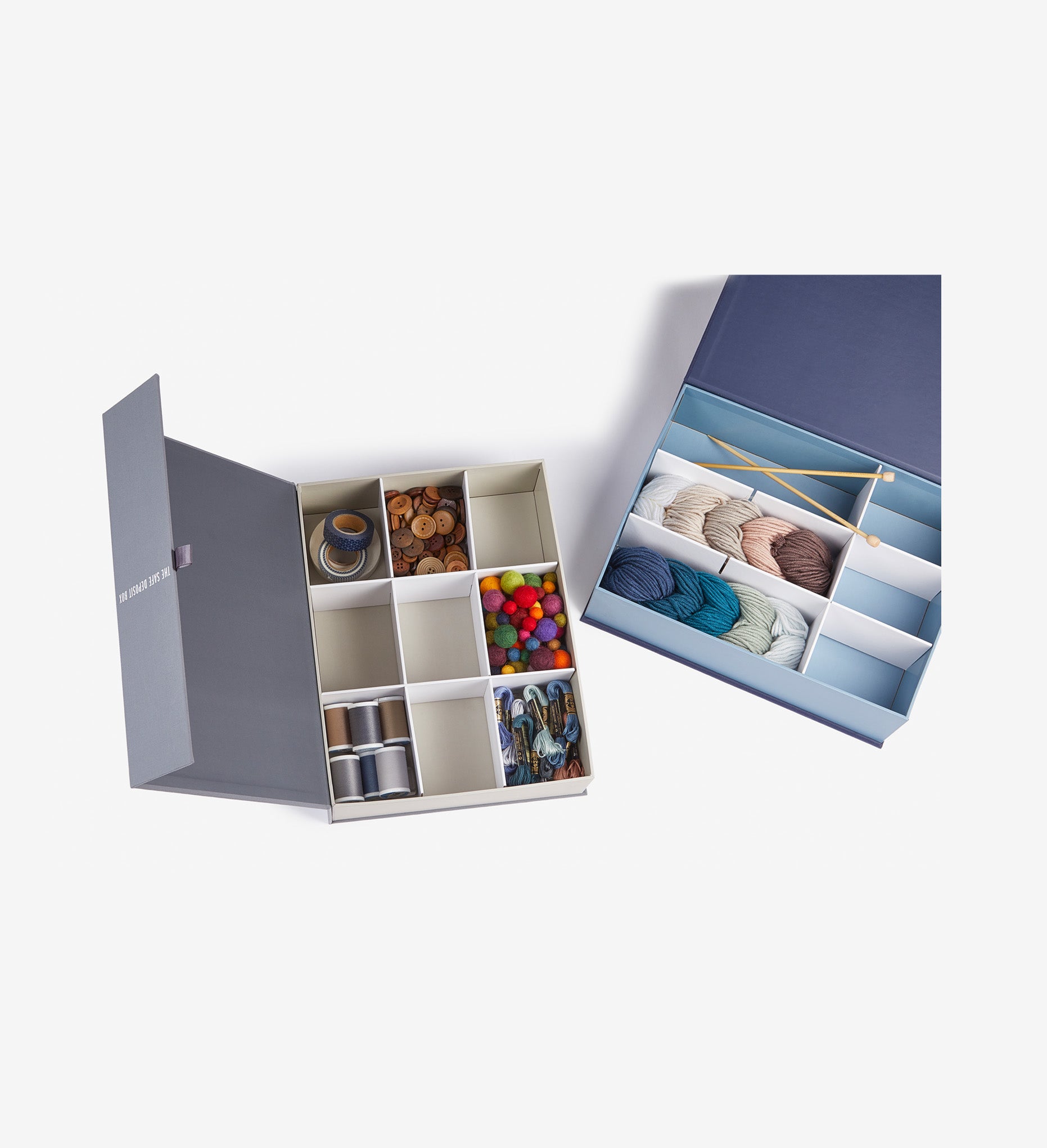 Two savor keepsake boxes open with knitting materials in one and sewing ones in the other one