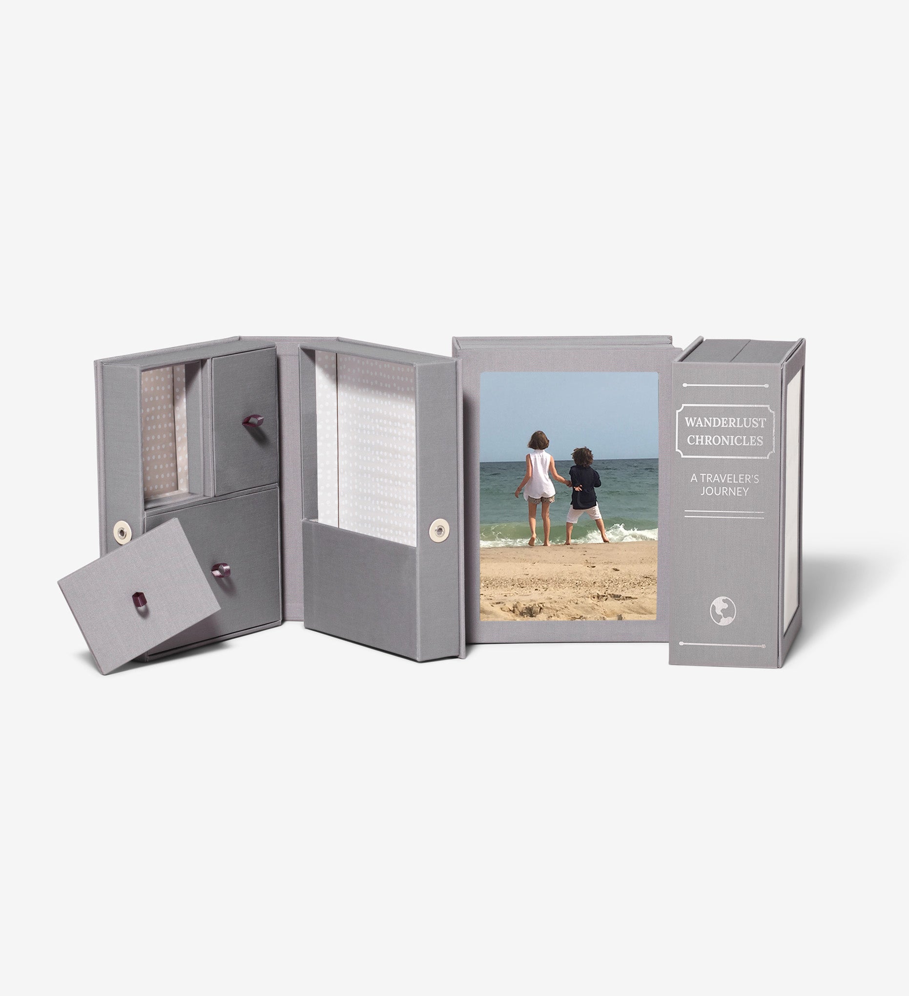 three slate story boxes, one is open, one is showing a photo of two kids at the beach and one is showing a personalized spine
