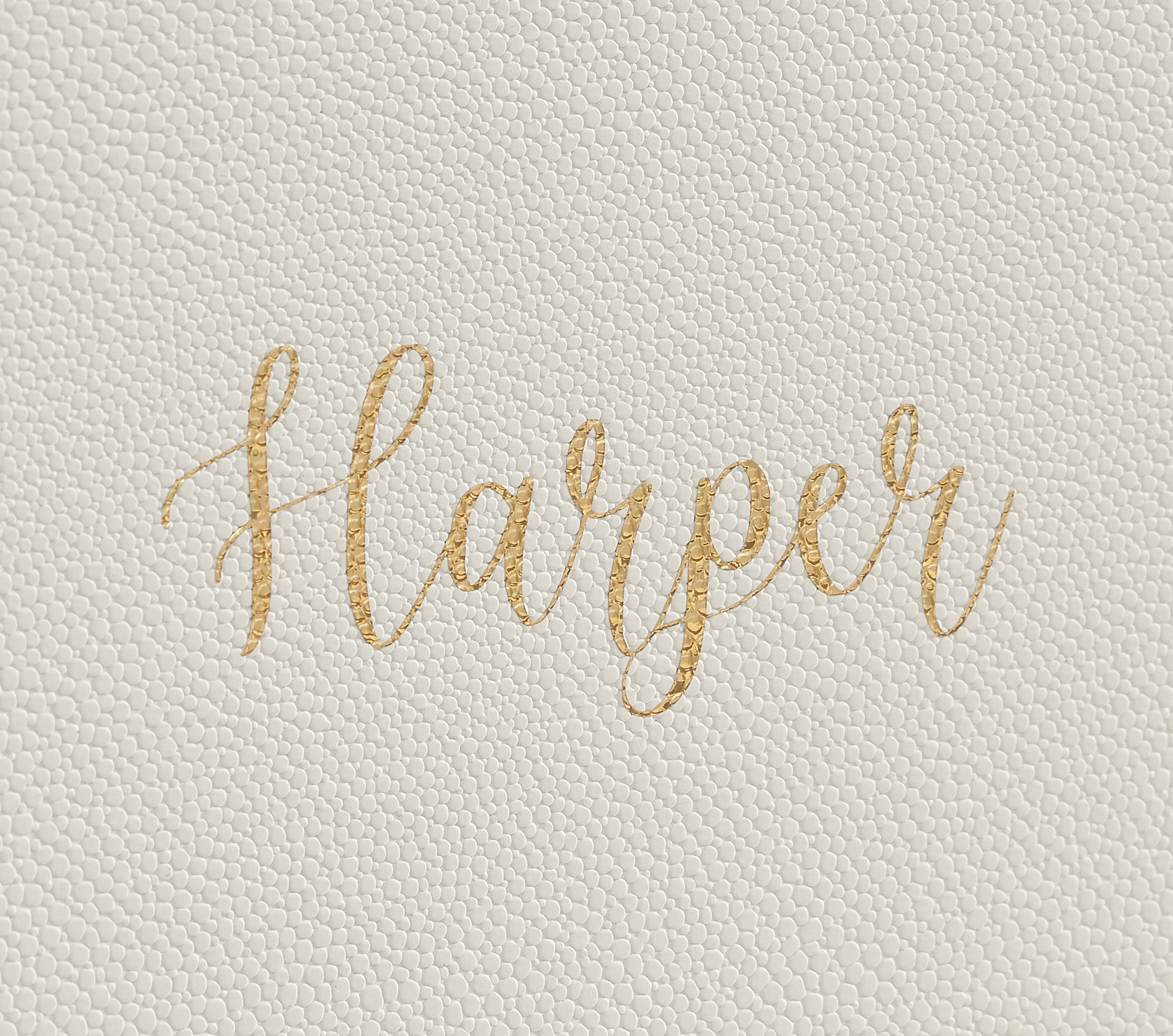 Close up on golden Harper personalization on an ivory shagreen keepsake vault.