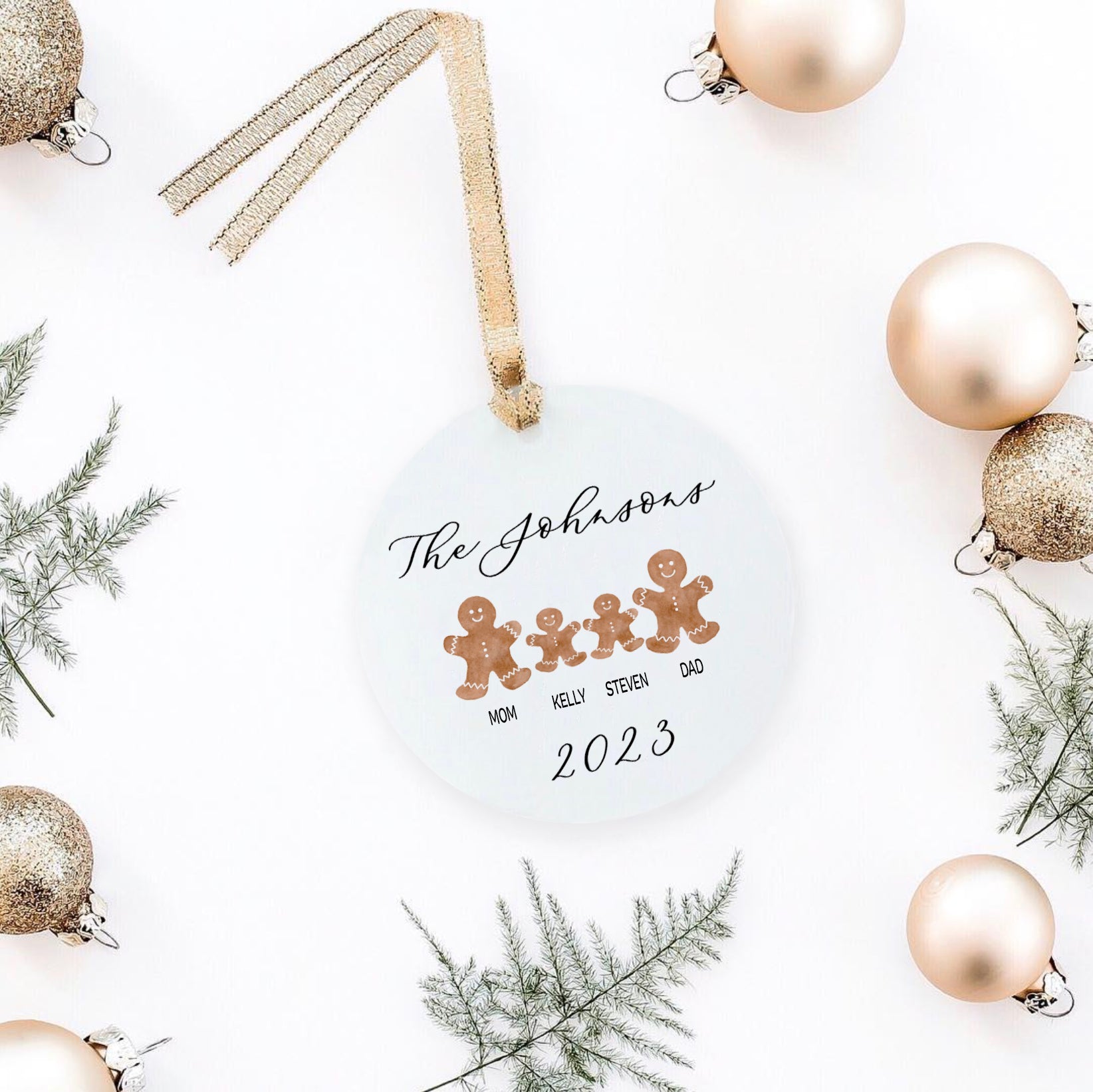 a christmas ornament personalized with laura and 4 gingergread cookies with christmas props.