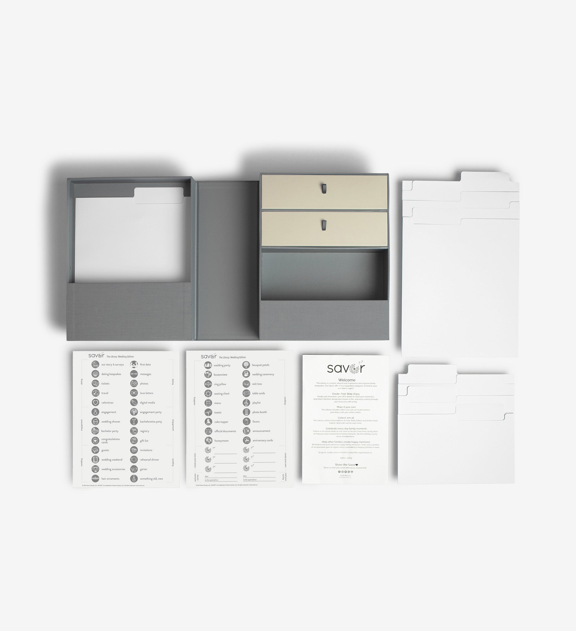 Slate wedding vault keepsake box flat lay with two label sheets, a welcome letter, a set of big folders and a set of small folders