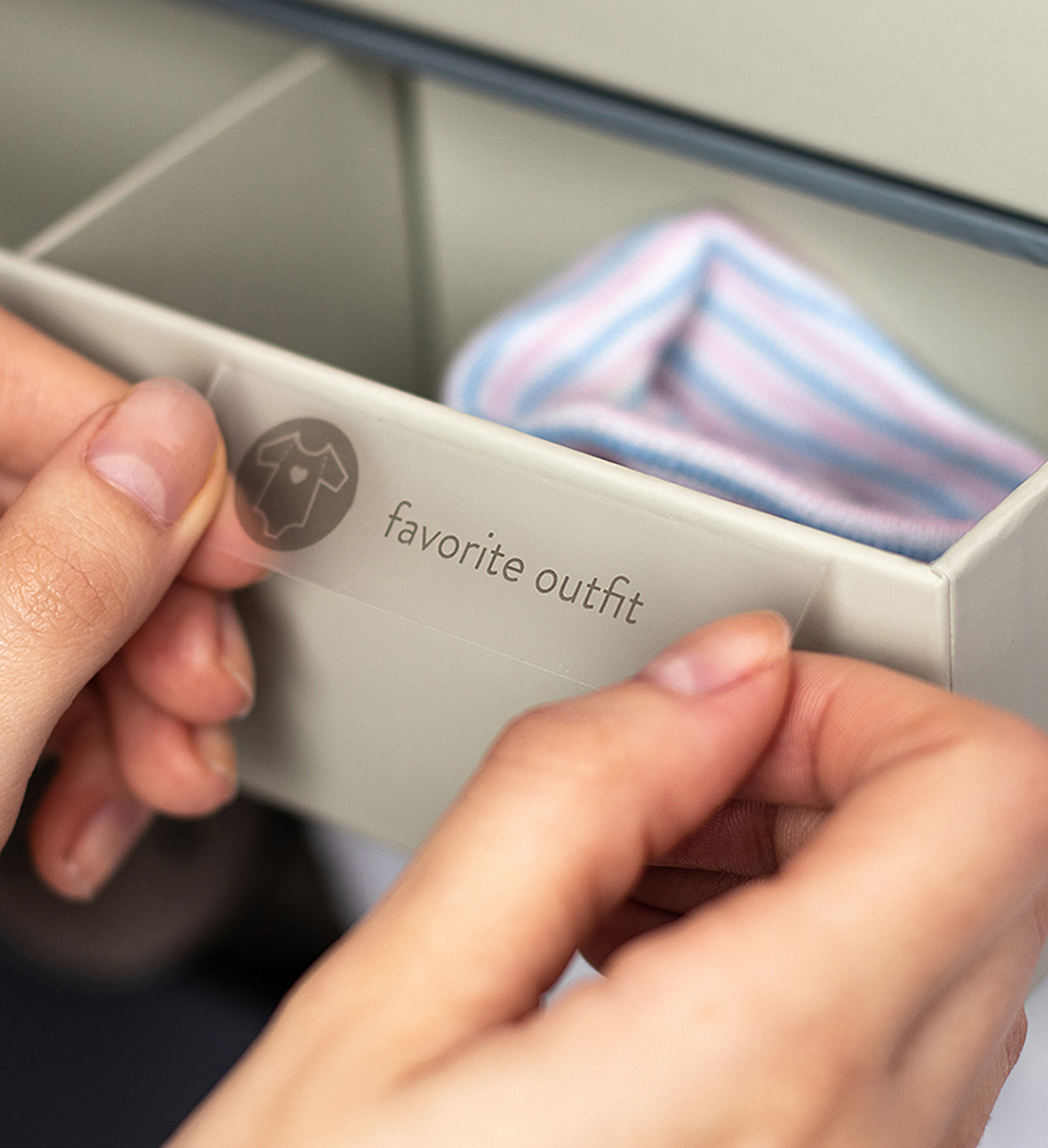 someone adding a label in a drawer from the keepsake box.