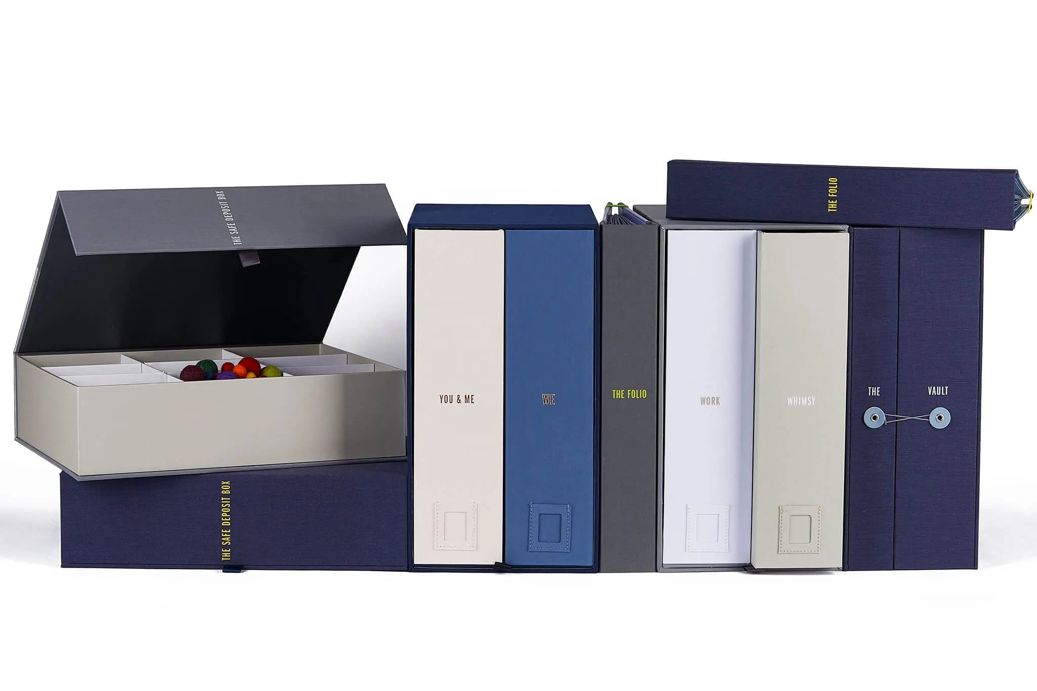 group shot of a vault, a binder, two wedding deluxe keepsake boxes (a slate one and a something blue one) and two overflox boxes