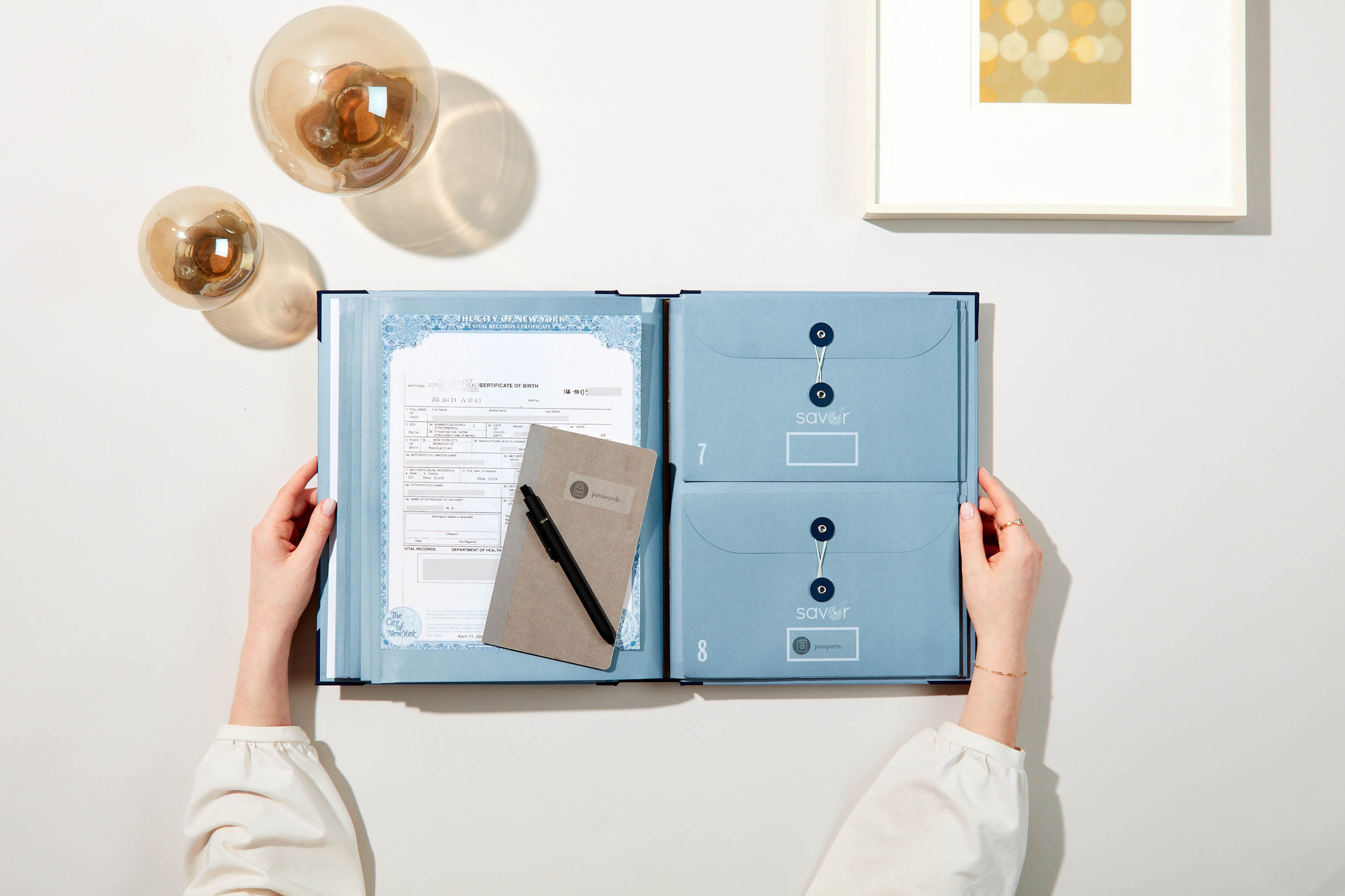 Blue organization folio with a hand putting a label on it.