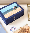 closed something blue travel story box with vacation photo on the cover of it.