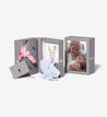 Savor slate story boxes, one open and one closed, with baby pictures and items