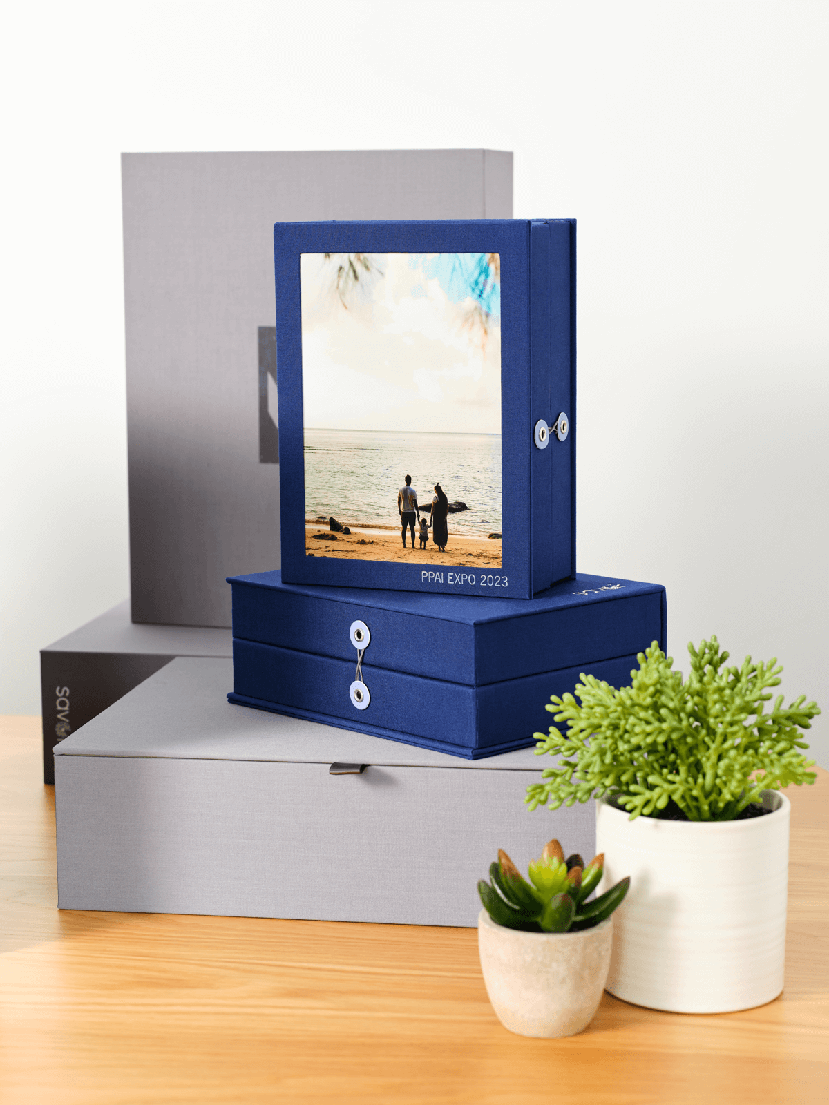Blue organization boxes with a picture of a family in the beach.