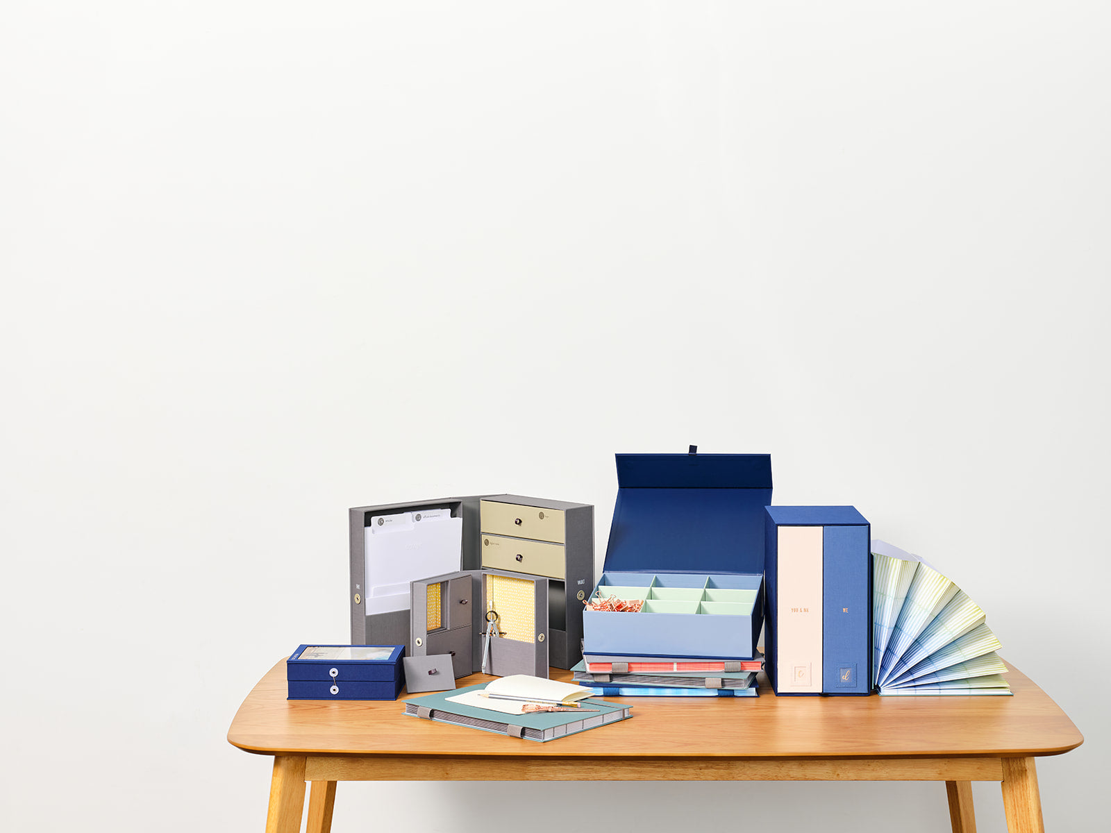 Savor keepsake boxes and fan folios on top of a table