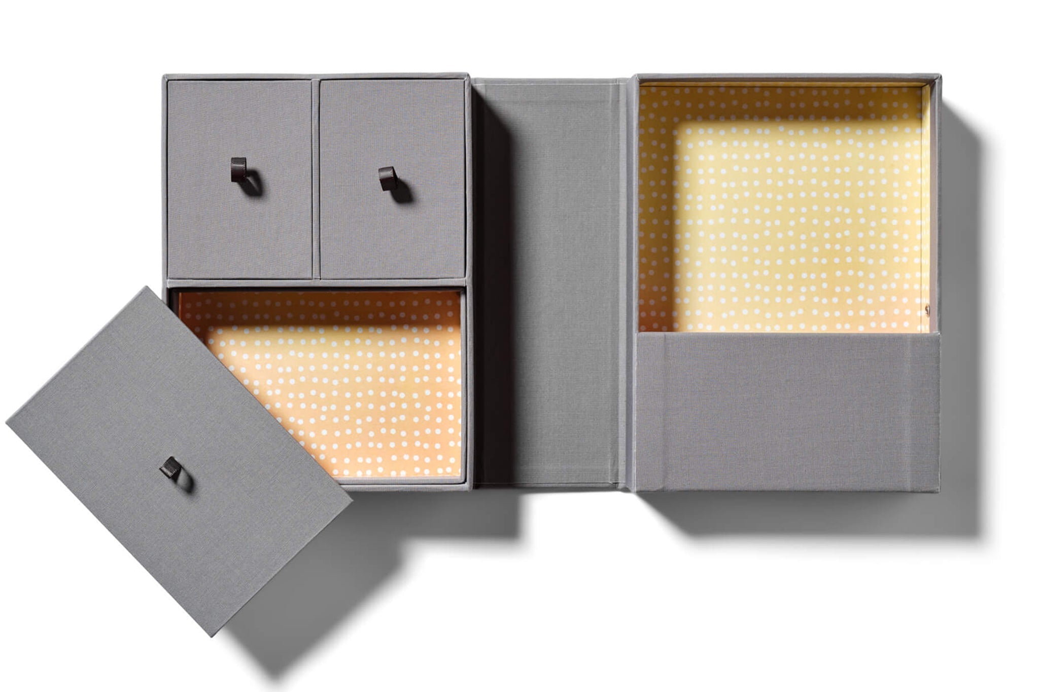 Gray keepsake box with yellow and orange interiors with white dots