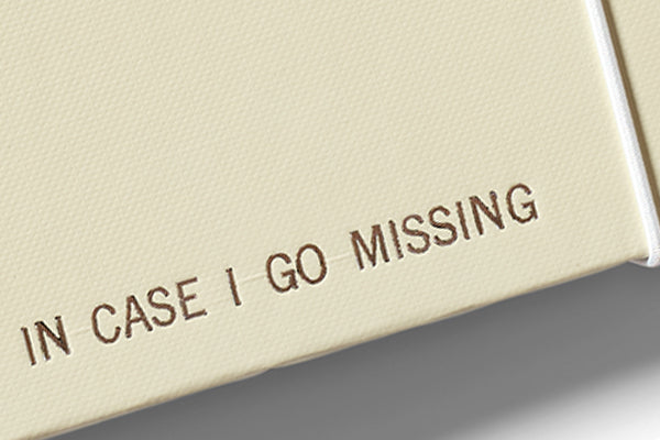close up on personalized in case i go missing binder metallic text on folio with beige background
