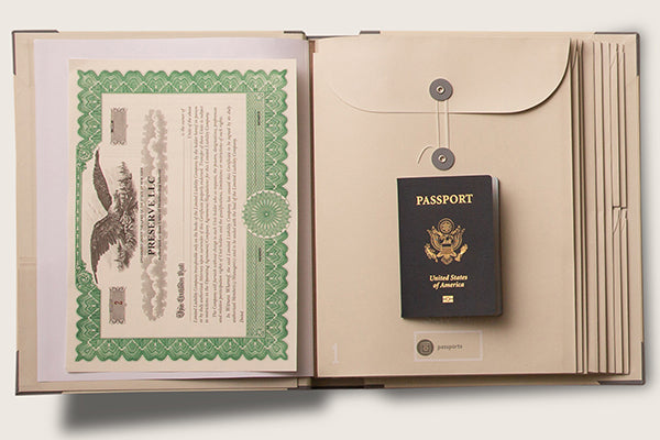 Savor Folio for important papers in slate offers 10 envelopes in a ray of sizes. shown here larger vertical envelope with passport and stock certificate.