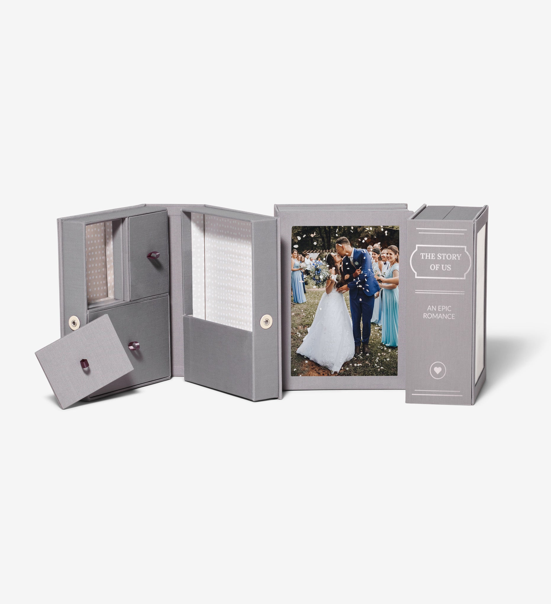 three slate story boxes, one is open, one is showing a photo of a couple at their wedding and one is showing a personalized spine