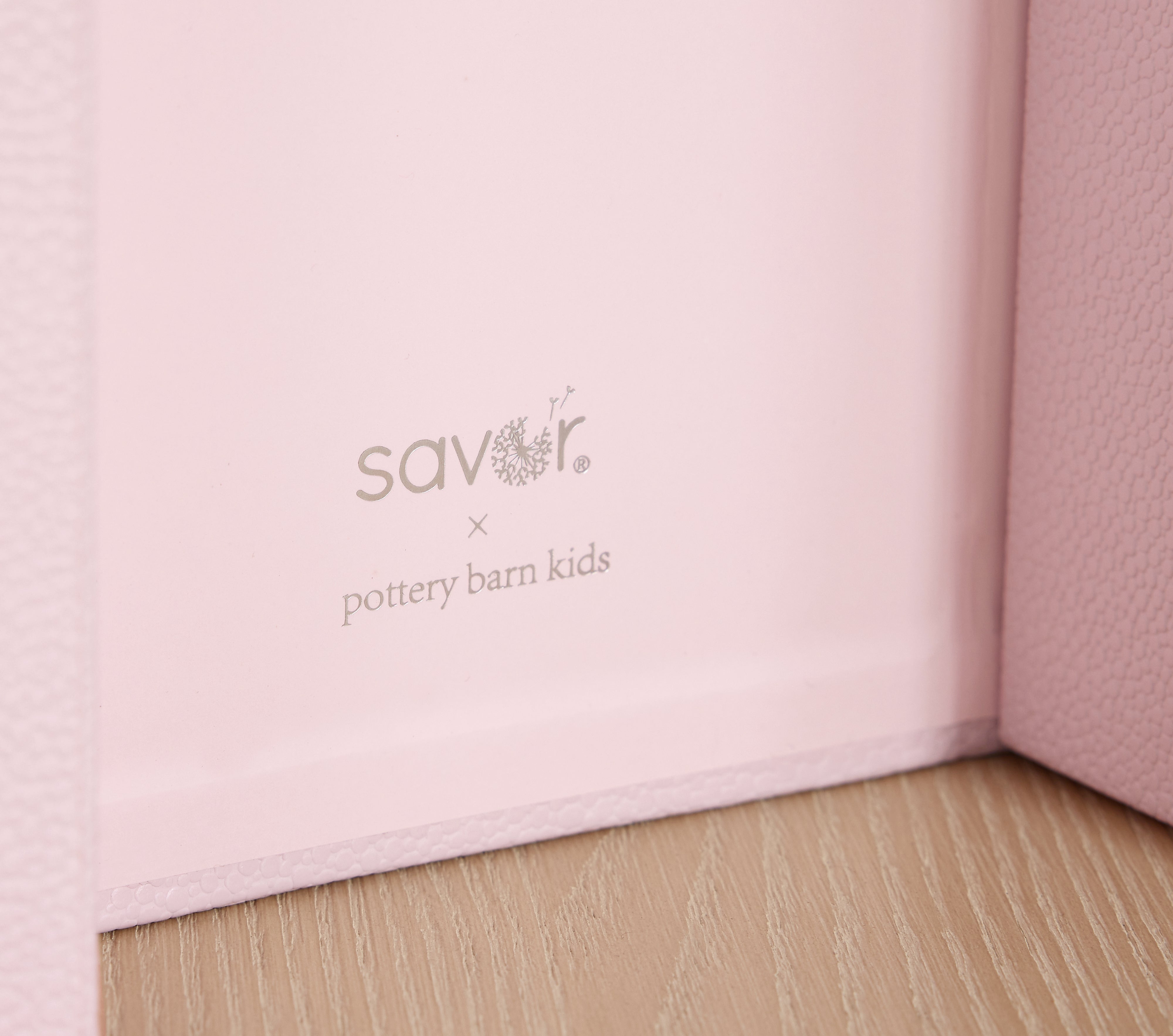 Close up on SavorxPBK logo on a petal shagreen vault