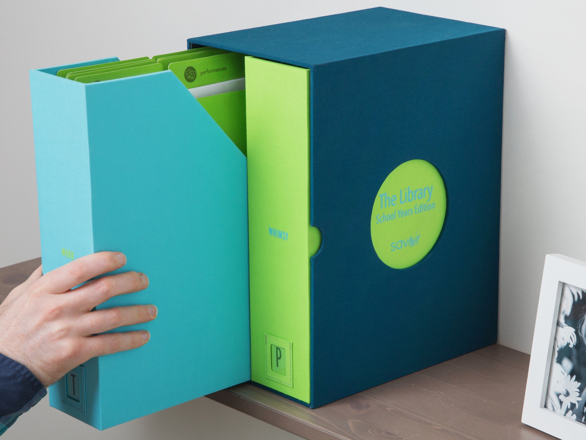 Someone taking out the set of folders from and ocean school years deluxe keepsake box.