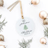 a christmas ornament personalized with laura and a tree with christmas props.