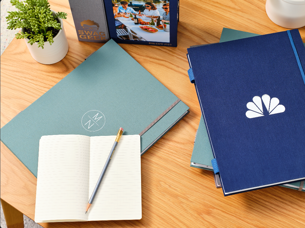 Savor organizers on top of a table: three fan folios with logos and a story box with a picture