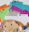 six file folders of different colors with props.