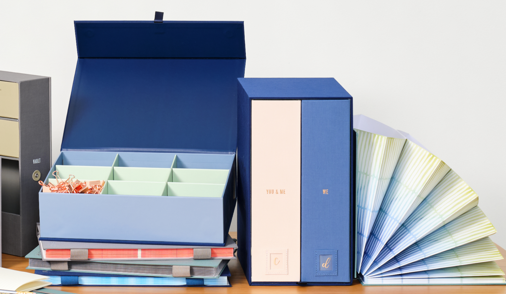 Blue organization boxes and a folio book on a table.