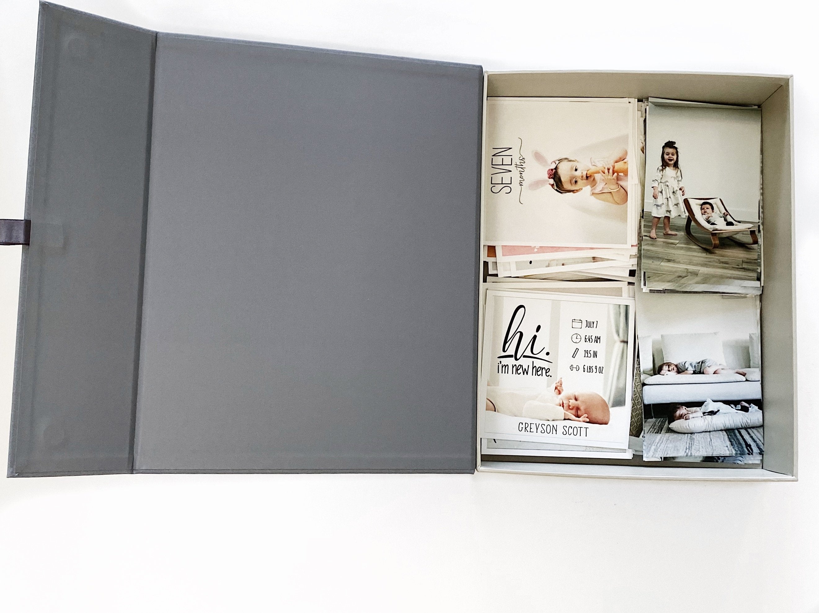 birdseye of an open slate overflow box with baby photos.