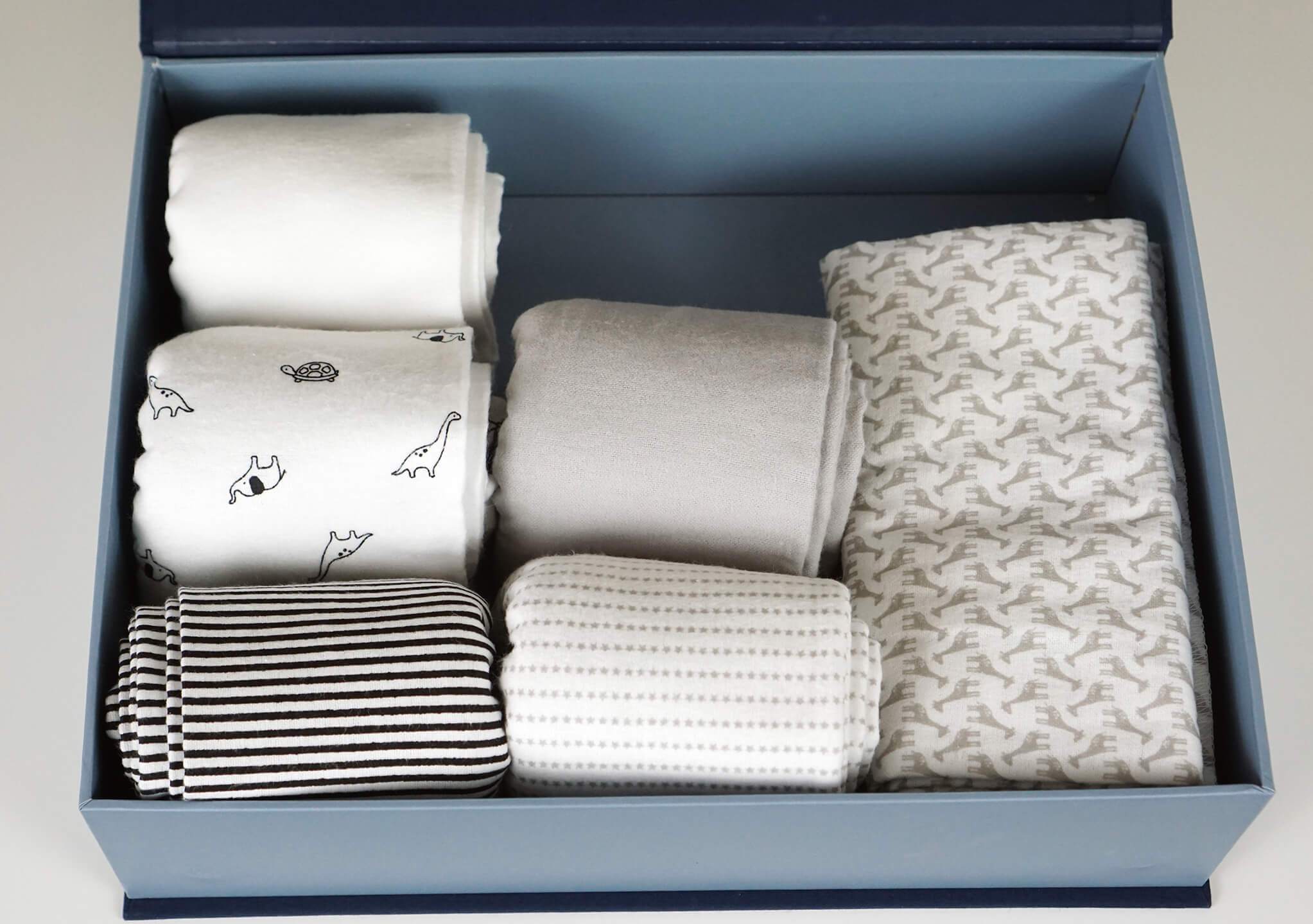 open slate overflow box with baby clothes.