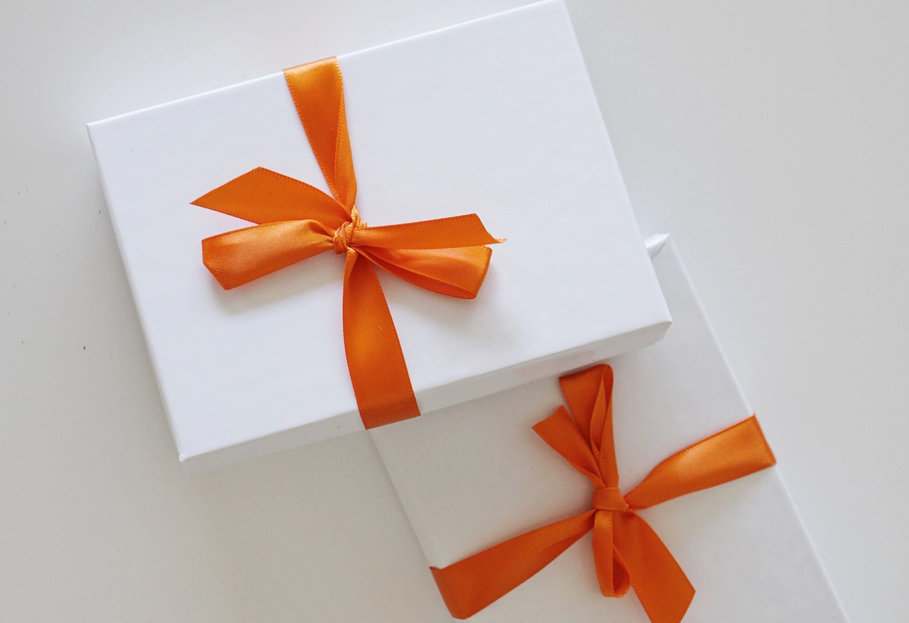 2 boxes with orange ribbon