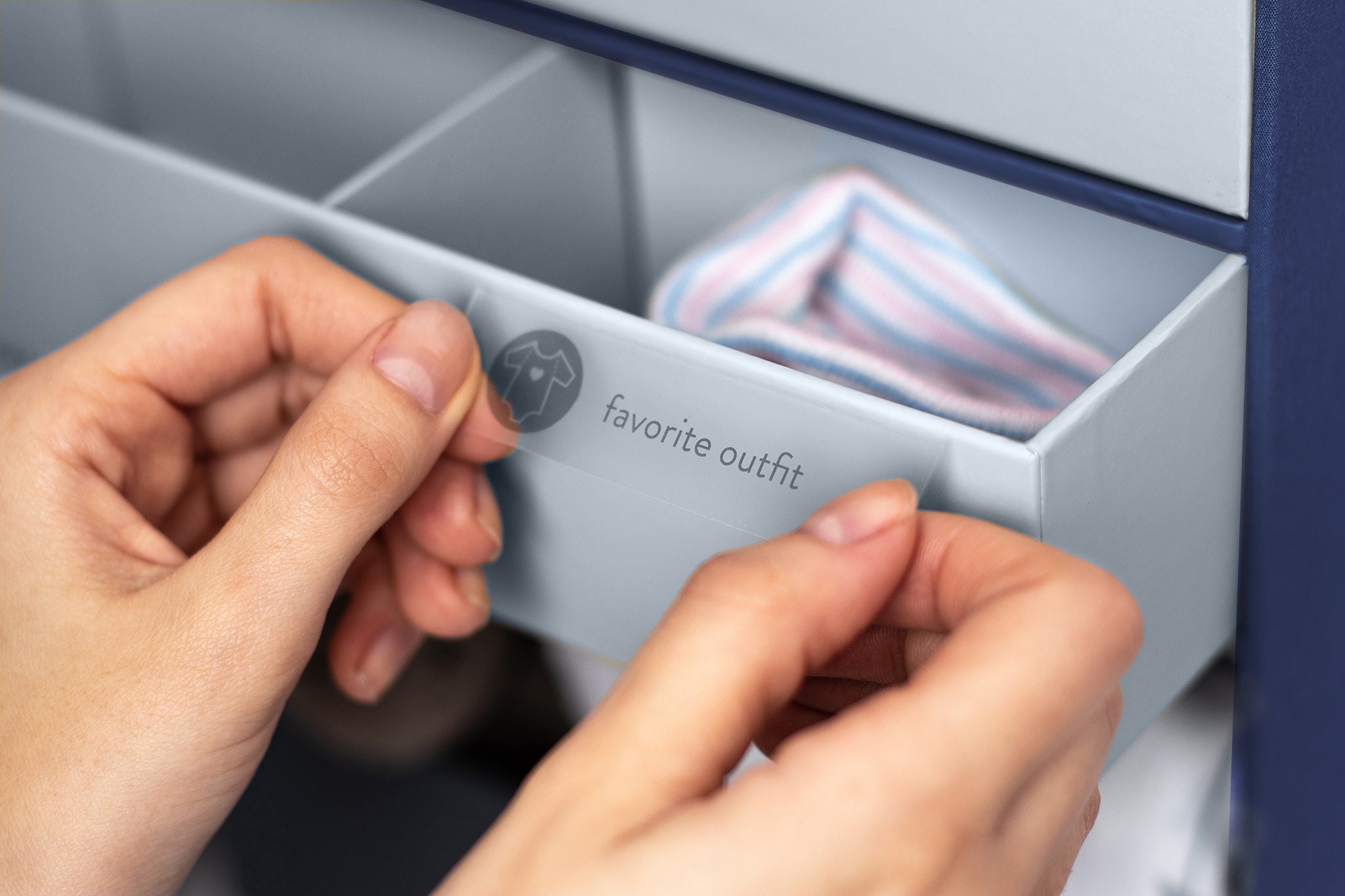 close up shot of someone applying a label on a drawer