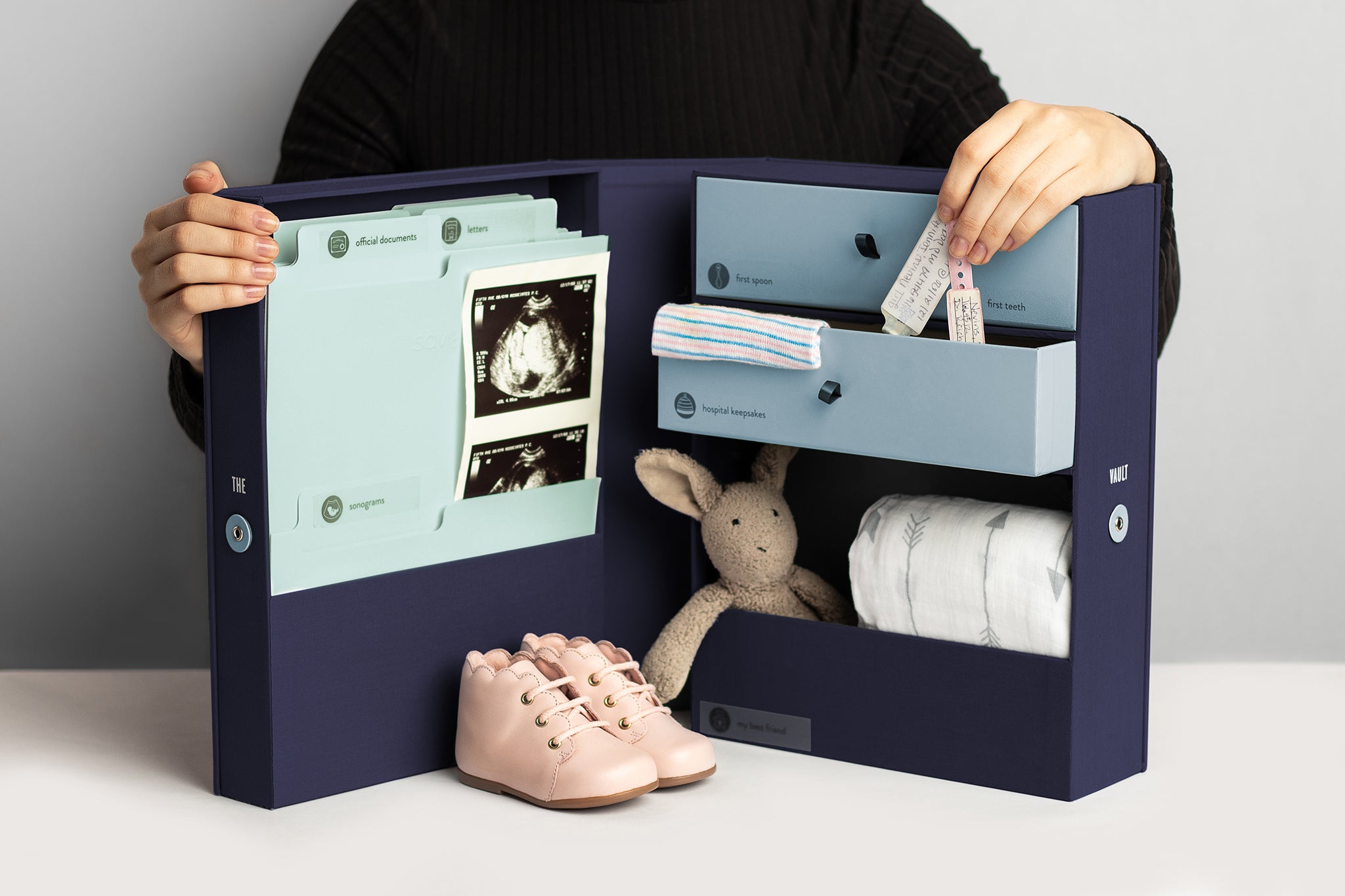 something blue baby vault keepsake box, with plushie, a blanket and sonogram, with person behind